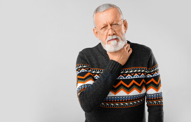 Ill old man with sore throat on white background