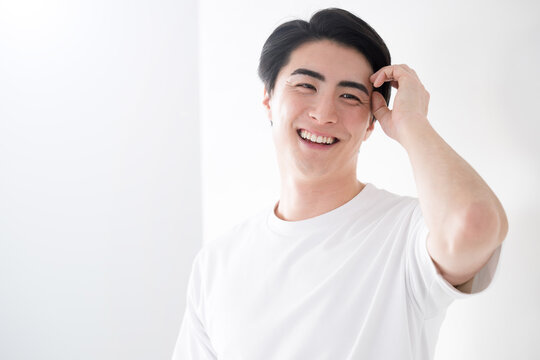 Asian (Japanese) man touching his hair Image of fresh hair removal and skin care  For men's beauty and beauty