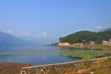 Fototapeta premium Beautiful morning around Phewa lek in Pokhara. Blue sky, clear water, clouds and landscape.