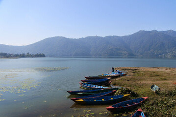 Fototapeta premium Beautiful morning around Phewa lek in Pokhara. Blue sky, clear water, clouds and landscape.