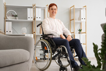 Young businessman in wheelchair at office