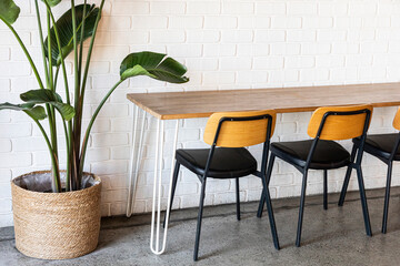 Empty Cafe Table and Chair Against White Brick Wall