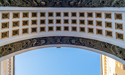 A view from below of the arch of an ancient building.