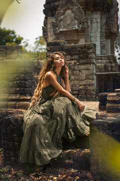 beautiful young woman in elegant dress at asian temple