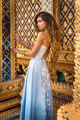 beautiful young woman in elegant dress at asian temple - 716119405