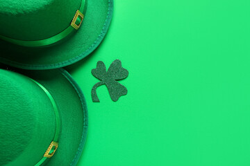 Paper clover with leprechaun's hats on green background. St. Patrick's Day celebration