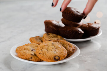 Hands taking brownies in background