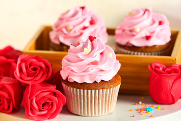 Tasty cupcake with rose flowers for Valentine's Day on white table