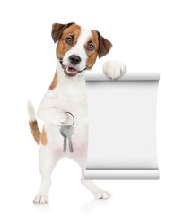 Jack russell terrier puppy holds in his paw the keys to a new apartment and shows empty list....