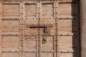 Close-up door-hardware on old wooden paneled door