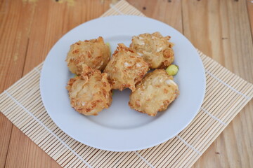 Bakwan sayur or vegetable fritter, Indonesian snack made from flour, cabbage, carrots and bean sprouts, served with chili