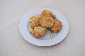 Bakwan sayur or vegetable fritter, Indonesian snack made from flour, cabbage, carrots and bean sprouts, served with chili