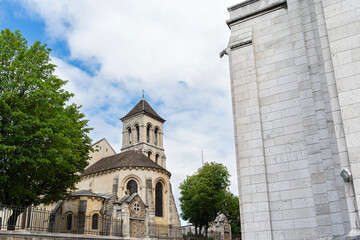 landmark church with apse chapel and bell tower visible behind fence in montmartre paris