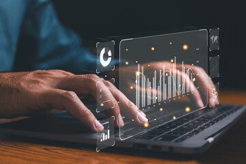 Businessman use laptop for Data analyst working on business analytics dashboard with charts, metrics and KPI to analyze performance and create insight reports operations management on virtual screen.