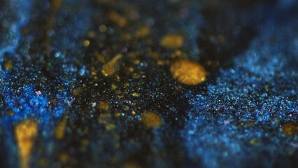 Glitter oil texture. Sparkling bubbles. Defocused blue golden yellow black color shimmering glowing ink moisture drops wave motion dark abstract art background.
