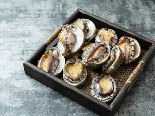 Fototapeta na wymiar Fresh abalone on wooden tray