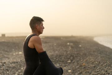 Fisherman taking off the wetsuit after working on the beach