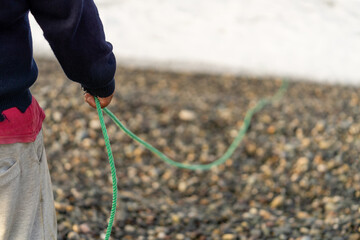 Fisherman gathering the rope and materials used for net fishing