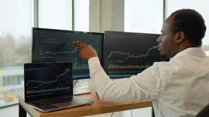 Focused crypto trader analyst looking at computer screen analyzing stock market charts - Powered by Adobe