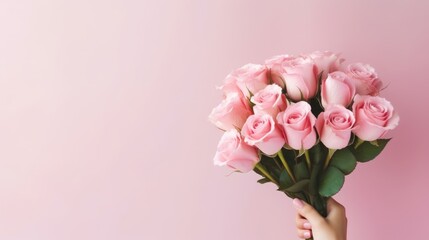 A bouquet of pink roses in women's hands for congratulations on Mother's Day, Valentine's Day, Women's Day. Blurred background.
