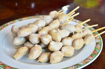 The many toast meat ball set in the plate for meal. To make grilled meatballs, skewers are used and then grilled over low heat until cooked. It's an easy food to eat.