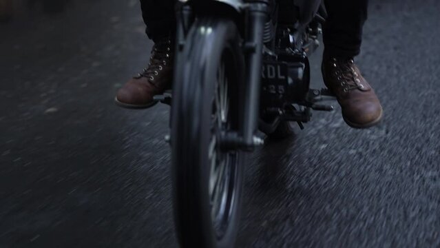 slow motion of a motorbike rider in the rain