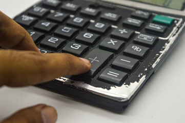 hand calculating using a calculator isolated on white background. perfect for Education, mathematics, and Business Article or Content.