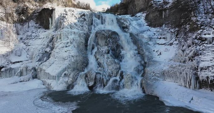 Afternoon winter aerial video of frozen Ithaca Falls on Fall Creek, City of Ithaca, NY, USA 01-21-2024