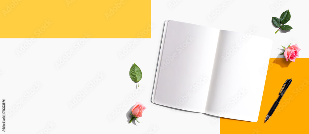 Poster open notebook or diary with a pen from above with rose buds- flat lay