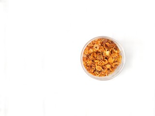Fried shallots on a white background. Staple condiment of Southeast Asian cuisine