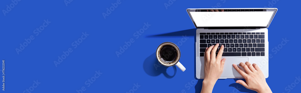 Sticker person using a laptop computer from above