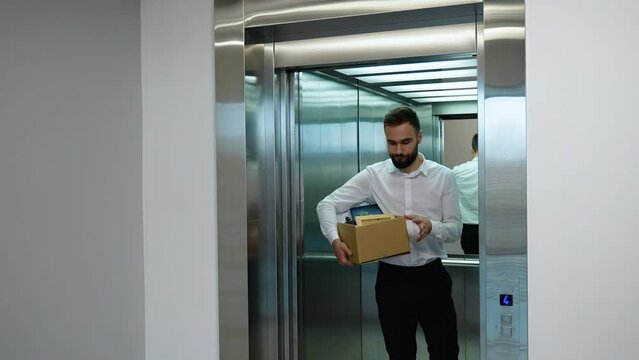 Dismissed worker with dismissal box coming out of lift