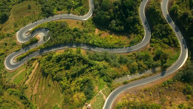 Top view of scenic winding road in the mountains on the Ha Giang Loop, North Vietnam.