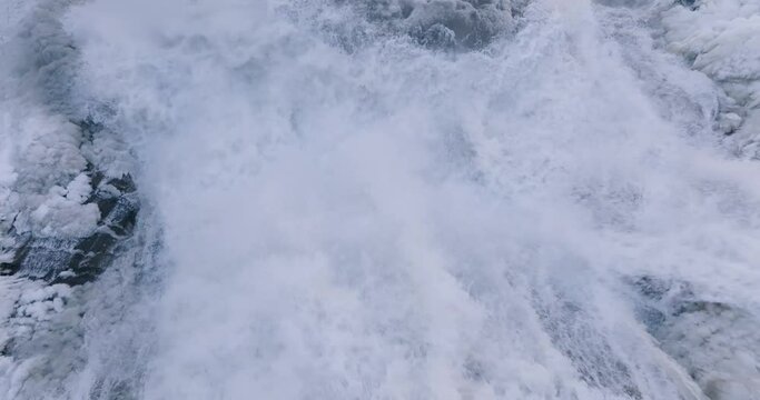 Afternoon winter aerial video of frozen Ithaca Falls on Fall Creek, City of Ithaca, NY, USA 01-21-2024
