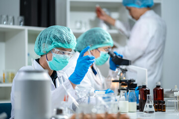 A Scientists or nutritionists are working on a sample of milk in biotechnology laboratory, genetic...