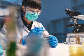 Technician scientist working, examining, analyzing or research the sample of experiment result in...