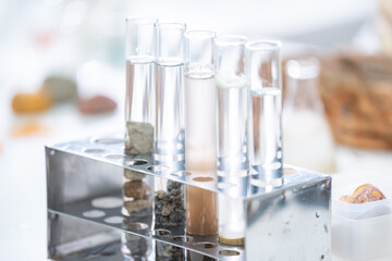 A laboratory equipment of researcher, geologist or archaeologist working with microscope and laptop studying, finding or discovering soil, rock, stone or fossil sample in archaeological and geological