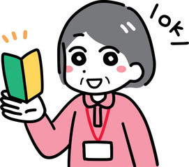 初心者マークを持つポロシャツのシニア女性