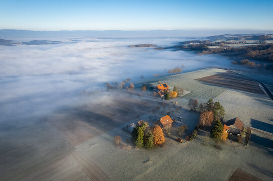Vue aérienne de la limite du brouillard avec une ferme et des arbres