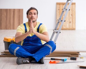 Young male contractor working indoors