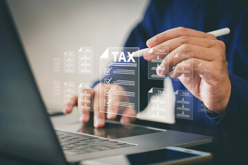 Tax concept. Person using computer to fill out personal income tax return to pay taxes online....