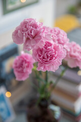 Pink carnations in a bottle on the table