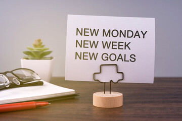 New Monday New Week New Goals on a Paper Note
