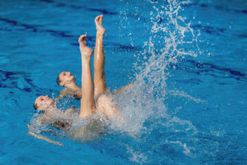 Synchronized swimming as this duet mesmerizes with fluid movements and elegant choreography in the pool