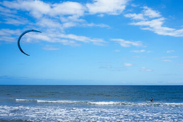 Person Parasailing in the Ocean on a Sunny Day