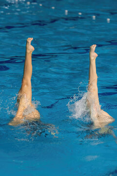 Synchronized swimming duet dance.  Synchronized swimming duet enchants the pool with their graceful dance