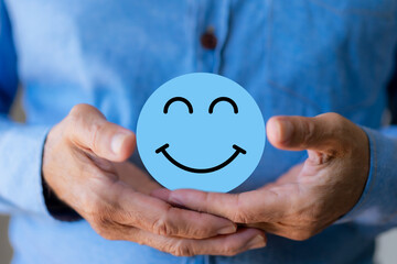 Hand holding paper cut circle symbol face smile, happy, relax, satisfaction survey, customer services, positive, good, wellness, health child, hospital, world mental health day concept.