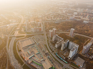 Aerial view of a beautiful city with multi-storey buildings, roads, parking lots and parks at...