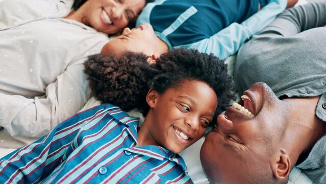 Parents, children and laughing in bed or above for morning connection for relax holiday, communication or love. Black man, woman and siblings happiness in home for rest together, vacation or funny