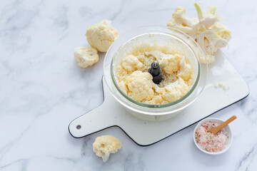 Preparing  cauliflower rice in a food processor, cauliflower in a blender.